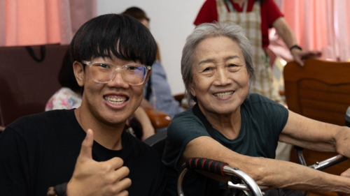 Students taking photos with their elders.(Open new window/png file)Image